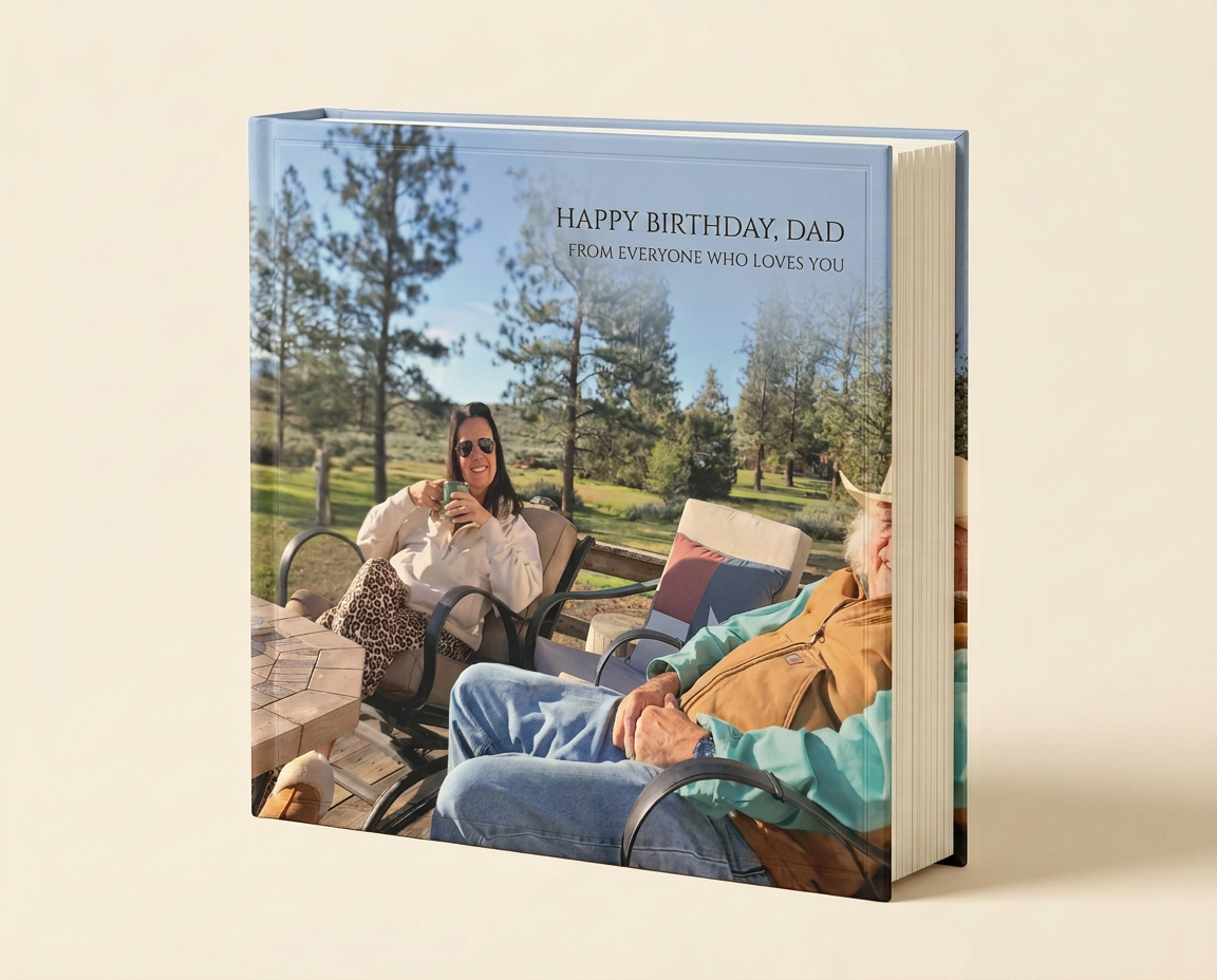 A thick hardcover GiftMemory birthday album, closed, with a family photo and the title Happy Birthday, Dad on the cover