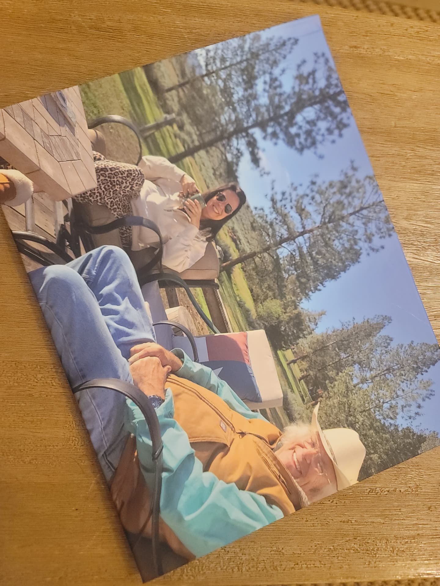 A printed GiftMemory hardcover book cover featuring a photo of a couple outdoors